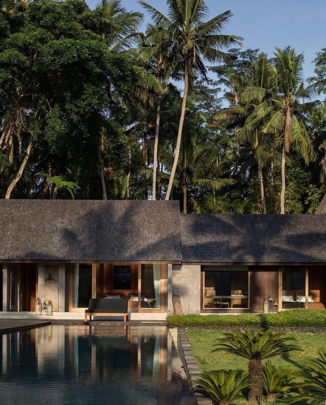 Luxury tropical villa surrounded by palm trees at the Samir Hospitality wellness retreat.