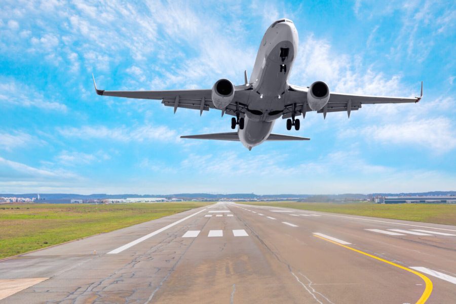 An airplane landing on a runway, symbolizing travel and arrival at the health and fitness retreat